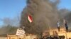 A headquarters building of Popular Mobilization Forces burns after being torched by demonstrators during ongoing anti-government protests, in Nassiriya, Iraq, Jan. 5, 2020.