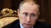 FILE - Russian President Vladimir Putin listens during a meeting at the Kremlin, in Moscow, Russia.