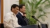 Philippine President Rodrigo Duterte (L) speaks with South Korean President Moon Jae-in during a joint press conference after their meeting at the presidential Blue House in Seoul, South Korea, June 4, 2018.