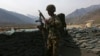 FILE - An Afghan National Army (ANA) soldier keeps watch at the Forward Base in Nari district near the army outpost in Kunar province, in this picture taken Feb. 24, 2014. 