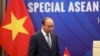 FILE - Vietnamese Prime Minister Nguyen Xuan Phuc walks to his desk ahead of the Special ASEAN summit on COVID-19 in Hanoi, Vietnam, April 14, 2020. 