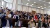 Somali parliament members raise their hands to approve the appointment of new Prime Minister Mohamed Hussein Roble, in Mogadishu, Sept. 23, 2020.
