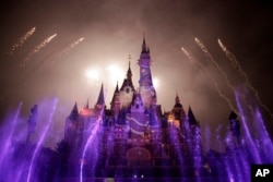 Fireworks are set off near the Enchanted Storybook Castle at the Shanghai Disney Resort in Shanghai. The Disney theme park is scheduled to open on June 16 this year, photo taken on May 31, 2016.