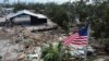 An American flag flies over the destroyed city hall in the aftermath of Hurricane Helene, in Horseshoe Beach, Florida, Sept. 28, 2024. 