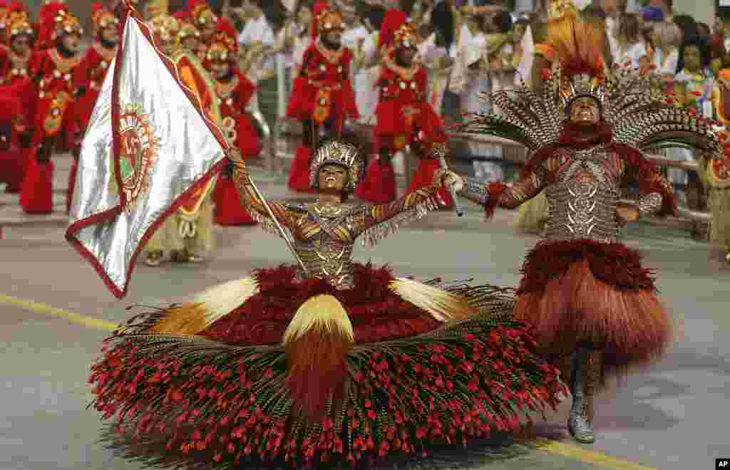 Dancers from the Mocidade Alegre samba school perform during a carnival parade in Sao Paulo, Brazil.