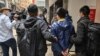 FILE - Ben Chung, 2nd right, of a pro-democracy political group is arrested by police in the Central district after as many as 50 Hong Kong opposition figures were arrested in Hong Kong, Jan. 6, 2021.