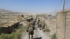 FILE - U.S. military advisers from the 1st Security Force Assistance Brigade walk at an Afghan National Army base in Maidan Wardak province, Afghanistan August 6, 2018.