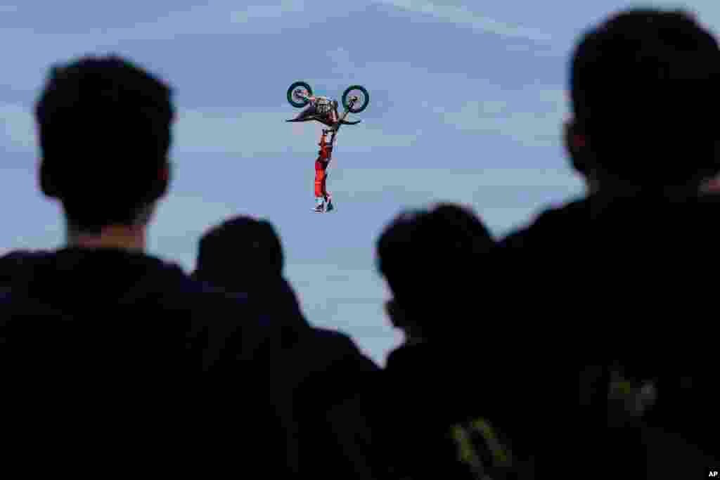 Riders perform during a freestyle motocross show at the EICMA exhibition motorcycle fair in Rho, outskirt of Milan, Italy, Nov. 7, 2024. 