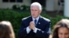 U.S. President Donald Trump gestures toward coronavirus disease testing machines as he holds an outbreak response news briefing in the Rose Garden of the White House in Washington, May 11, 2020. Vice President Mike Pence was notably absent.