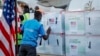 FILE - A UNICEF worker checks boxes of the Moderna coronavirus vaccine, donated by the U.S. government via the COVAX facility, after their arrival at the airport in Nairobi, Kenya, Aug. 23, 2021. 