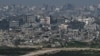 An Israeli flag flutters amid ruins in the Gaza Strip as the conflict between Israel and the Palestinian Islamist group Hamas continues, as seen from Israel, Feb. 13, 2024.