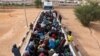 FILE - Migrants in a truck arrive at a detention center in Gharyan, Libya, Oct. 12, 2017. 