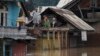 Flood-affected Kashmiris shout out for help from the roof of a house in Srinagar, India, Sept. 9, 2014. 