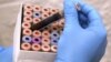 FILE - A lab technician is seen sorting viles of blood for testing.