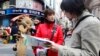 A Japanese tourist (R) speaks to a volunteer interpreter in Central Seoul April 8, 2013.