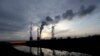 FILE - Smoke rises from chimneys of the Turow power plant located by the Turow lignite coal mine near the town of Bogatynia, Poland, Nov. 19, 2019. 