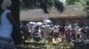 Chaos reigns outside Zimbabwe's registrar general's office in Harare as citizens wait to get various documents such as passports, birth certificates and identity documents, June 2019. (C. Mavhunga/VOA)