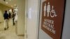 FILE- A sign marks the entrance to a gender-neutral restroom at the University of Vermont in Burlington, Vermont.