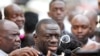 FILE - Uganda's main opposition leader Kizza Besigye (C) speaks to the media in Uganda's capital Kampala, Oct. 4, 2016.