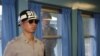 A North Korean soldier looks through a window as a South Korean stands guard at the U.N. truce village building that sits on the border of the Demilitarized Zone in Panmunjon, South Korea. (File)