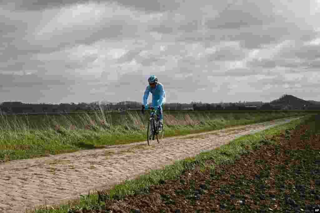 An Astana team cyclist trains ahead of Sunday&#39;s 114th edition of the Paris-Roubaix cycling classic, in Haveluy, northern France.