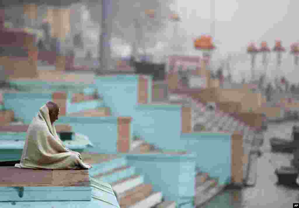 An Indian holyman meditates on the Ghats of the Ganges River ahead of Japanese Prime Minister Shinzo Abe&#39;s visit, in Varanasi, India. Indian PM Narendra Modi hopes the visit this weekend by Abe will be a major step in transforming India into an economic powerhouse with Japan&#39;s help in building bullet trains, &quot;smart cities&quot; and nuclear technology exchange.