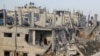 Palestinians inspect the site of Israeli strikes in Khan Younis