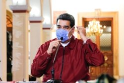Venezuelan President Nicolas Maduro wearing a face mask while speaking during a televised announcement over the global COVID-19 pandemic, in Caracas, Venezuela on March 13, 2020.