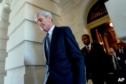 FILE - Former FBI Director Robert Mueller, the special counsel probing Russian interference in the 2016 election, departs Capitol Hill following a closed-door meeting in Washington, June 21, 2017.