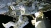 In this still image taken from NASA TV, International Space Station astronauts Chris Cassidy (top) and Tom Marshburn work on repairs to the ISS on May 11, 2013. 