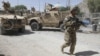 A US soldier, part of the NATO forces, patrols a police station after it was attacked by militants in Kandahar, south of Kabul, Afghanistan, June 19, 2012.