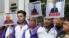 Members from Civic Party, holding portraits of (L-R) Wang Qingying, Yuan Chaoyang and Tang Jingling, protest outside China's Liaison Office in Hong Kong, China, Jan. 29, 2016.