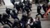 Protesters clash with French riot police during a demonstration to mark the first anniversary of the "yellow vest" movement in Nantes, France, Nov. 16, 2019. 