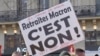 A sign denouncing President Emmanuel Macron's pension reforms notes that the protest movement marked its 51st day, Jan. 24, 2020, in Paris. (Lisa Bryant/VOA)