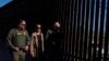 US Vice President Kamala Harris talks with John Modlin, chief patrol agent for the Tucson Sector of the US Border Patrol, right, and Blaine Bennett, US Border Patrol Douglas Station border patrol agent in charge, at the US border with Mexico in Douglas, Ariz., Sept. 27, 2024. 