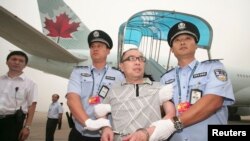 FILE - Chinese fugitive Lai Changxing is escorted back to Beijing from Canada, at Beijing International Airport, July 23, 2011.