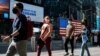 FILE - People with masks to protect against the coronavirus walk in Times Square, in New York City, July 23, 2021. 