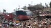 A ship lies on top of damaged homes after it was washed ashore in Tacloban city, Leyte province, central Philippines, Nov. 10, 2013.