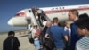 FILE - Passengers board an Air Koryo plane at the Pyongyang International Airport, in Pyongyang, North Korea, June 27, 2015.