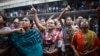 Garment workers shout as they call on other workers to join them during a protest in Dhaka September 23, 2013.