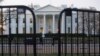 In this March 24, 2019 photo, The White House is seen behind security barriers. A White House official turned whistleblower says dozens of people in President Trump’s administration were granted access to classified information despite “disqualifying issues” in their backgrounds.