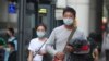 People wear face masks to protect against the coronavirus, in Taipei, Taiwan, Feb. 26, 2020. 
