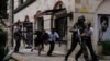 FILE - Kenyan security forces help people to escape after a bomb blast at DusitD2 hotel in Nairobi, Kenya, Jan. 15, 2019. 
