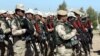 Kurdish Peshmerga fighters take part during a training session by coalition forces in a training camp in Irbil, north of Iraq, March 9, 2016.