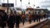 Passengers walk on a platform at the Gare de Lyon railway station in Paris as a strike by French SNCF railway workers and French transportation workers continue to protest against French government's pensions reform plans in France, Dec. 6, 2019.