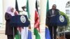 Kenya's President Uhuru Kenyatta, right, listens as Tanzanian President Samia Suluhu Hassan speaks during a joint press conference at the State House in Nairobi, May 4, 2021. 
