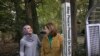 Heba Macksoud, left, of Princeton, New Jersey, and Sheryl Olitzky, members of the Sisterhood of Salaam Shalom, stand near a Peace Pole, with English and Arabic writings, in North Brunswick, New Jersey, Oct. 17, 2019.