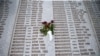 FILE - A memorial plaque lists victims' names, in the Srebrenica-Potocari Genocide Memorial Center, Bosnia and Herzegovina, June 8, 2021.