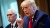 U.S. President Donald Trump and Vice President Mike Pence, left, along with members of the coronavirus take force meet with pharmaceutical executives in the Cabinet Room of the White House in Washington, March 2, 2020.