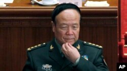 FILE - Guo Boxiong rubs his face during a session of the National People's Congress held in Beijing.
